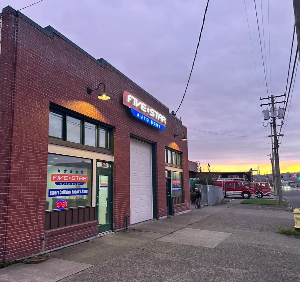 Five Star Auto Body Longview WA storefront at 760 Commerce Ave, brick building with lit sign and service bay